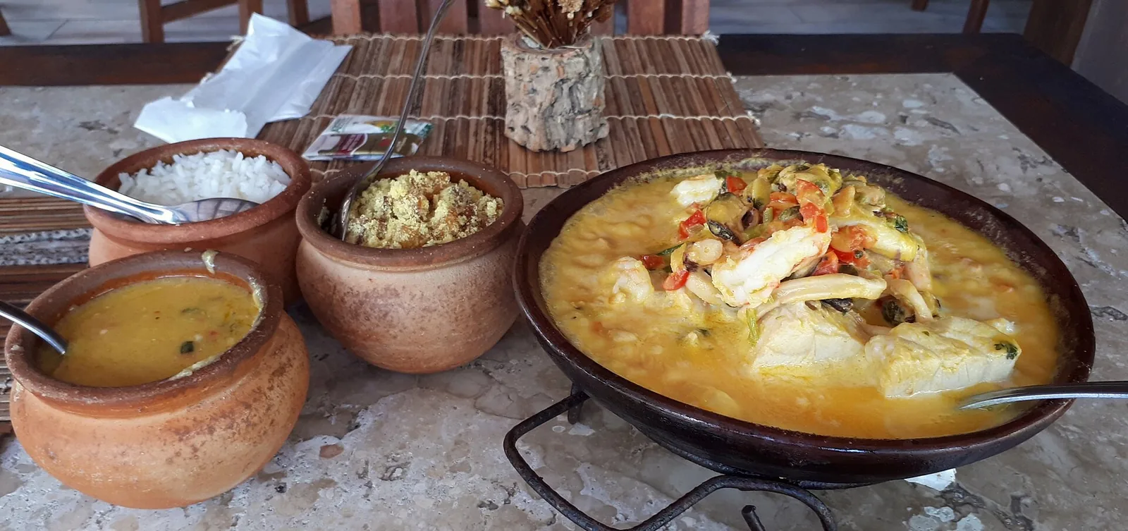 Moqueca, the coastal seafood stew — here in the Bahian style, rich with dendê palm oil and coconut milk.