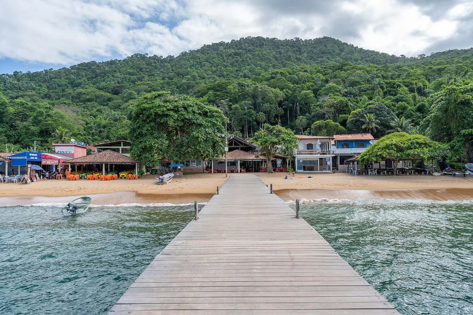 The jetty at Lagoa Azul, where boats anchor over a shallow, glass-clear lagoon on Ilha Grande.