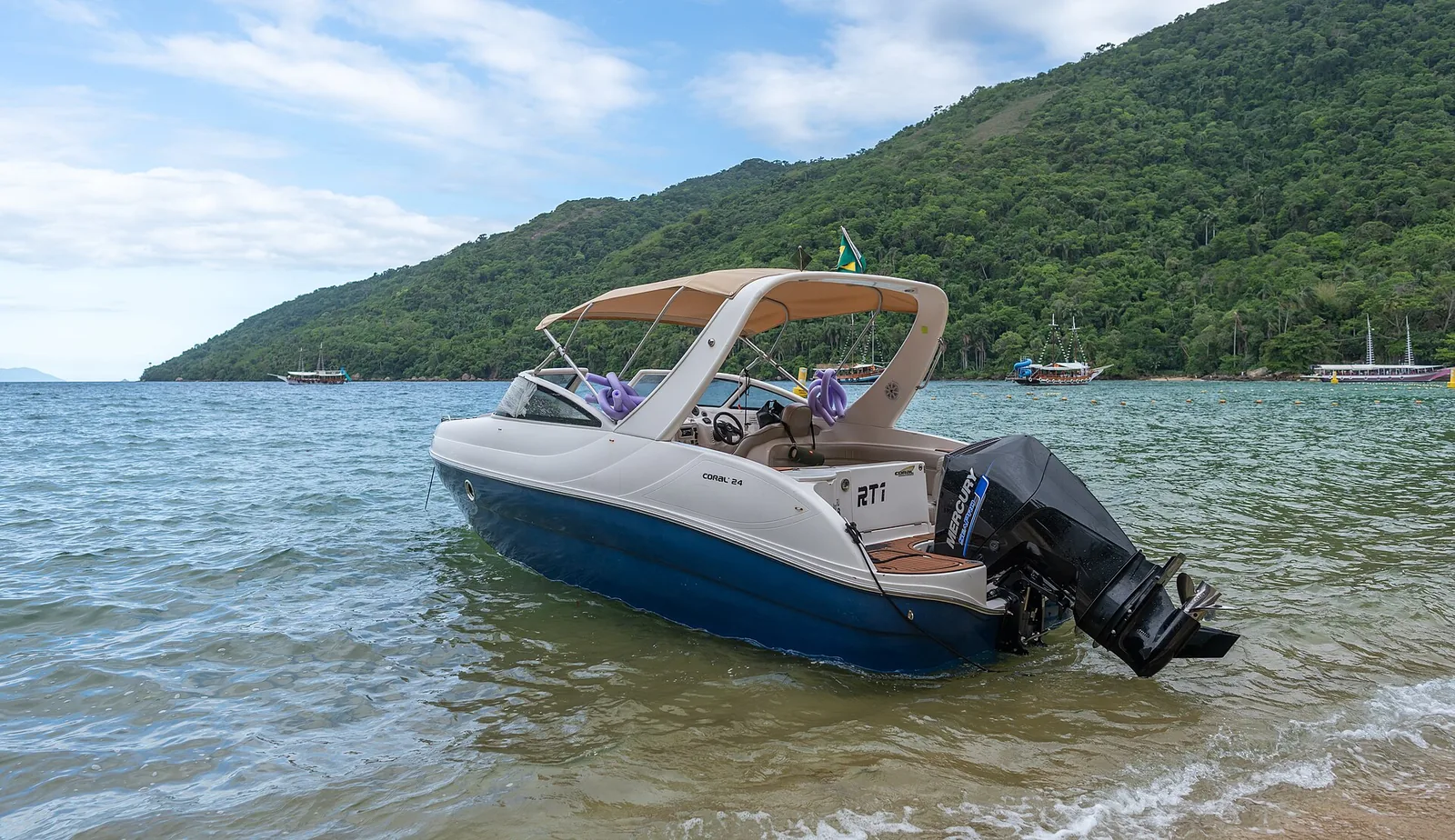 A launch crossing the bay — most people reach Lopes Mendes by boat to Pouso, then walk the last stretch.