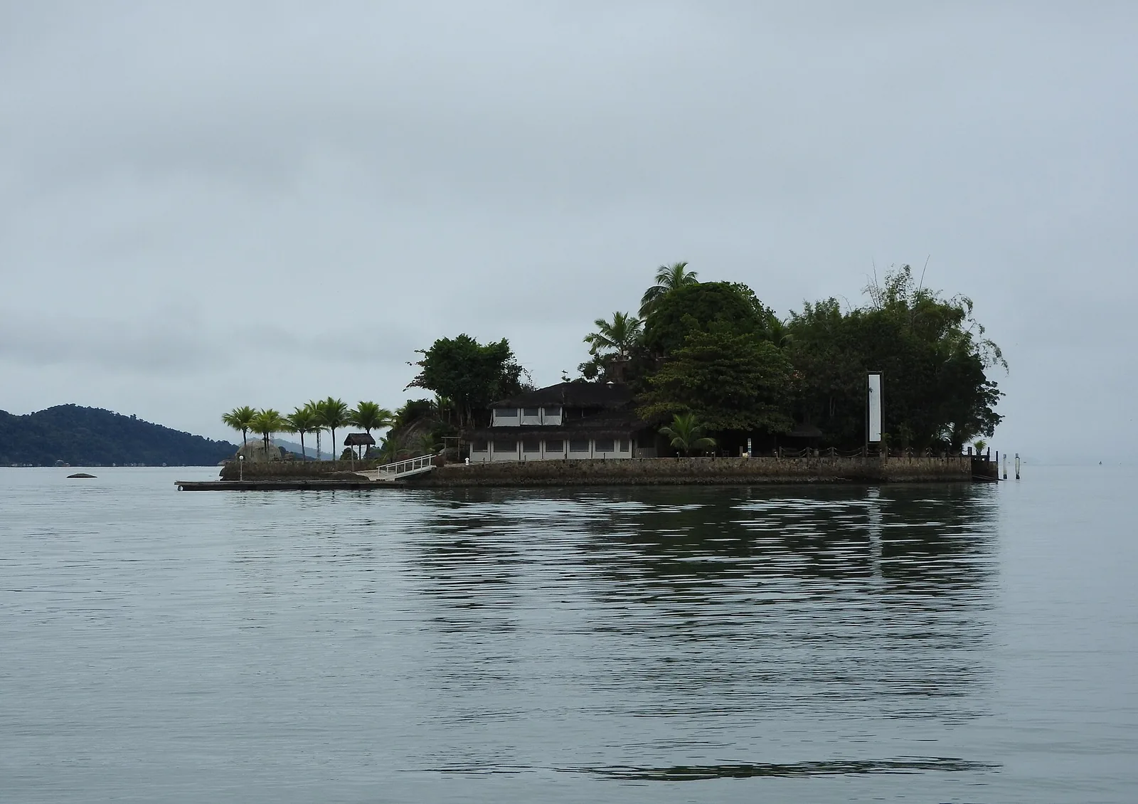 The bay sits inside the Cairuçu protected area: anchor over sand or mud, well clear of the mangroves and the oyster farms.